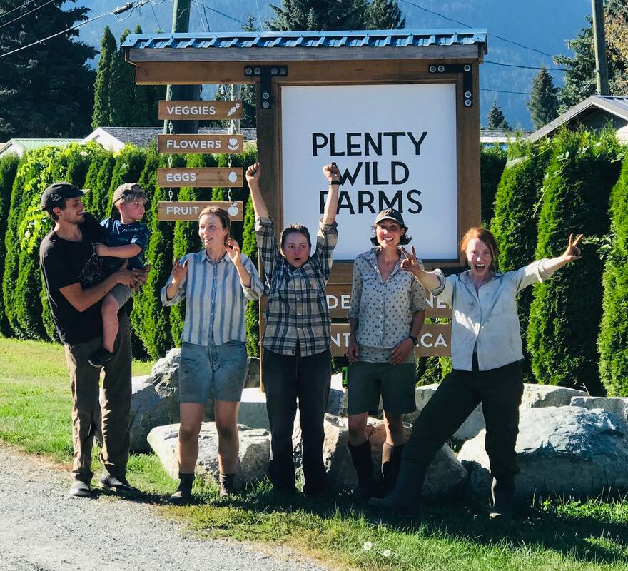 The 2020 Plenty Wild Farms crew pose in front of their farm sign